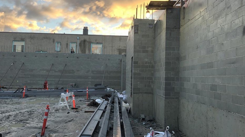 Masonry wall on South side and wall and elevator shaft on East side, level 1 complete, October 2018